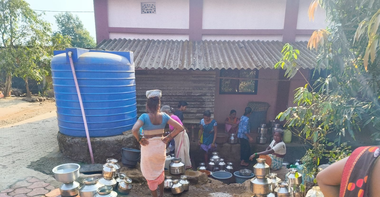 Households drawing water at a village supply point — Chafewadi, Maharashtra, March 2026.